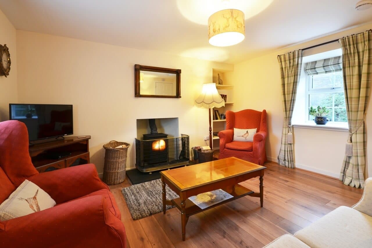 Sitting room with wood burner Keepers Cottage - Dunrobin Holiday Cottages, Caithness